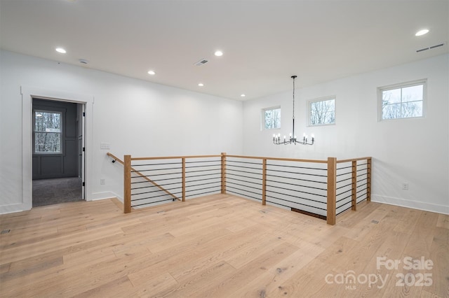 6630 Vesuvius Furnace Rd Unit 1, Denver, NC 28037 - empty room featuring visible vents, wood finished floors, recessed lighting, baseboards, and a chandelier