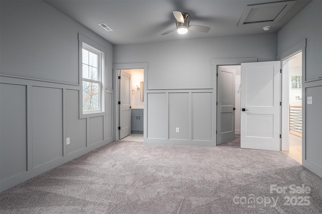 6630 Vesuvius Furnace Rd Unit 1, Denver, NC 28037 - unfurnished bedroom with a ceiling fan, visible vents, ensuite bath, a decorative wall, and carpet flooring