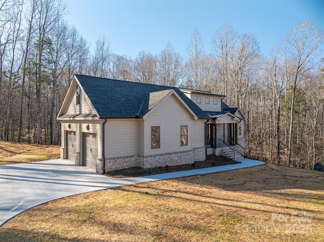 view of side of home with a lawn, an attached garage, driveway, and a shingled roof