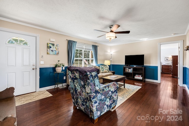 living room with a textured ceiling, dark hardwood / wood-style flooring, ceiling fan, and crown molding