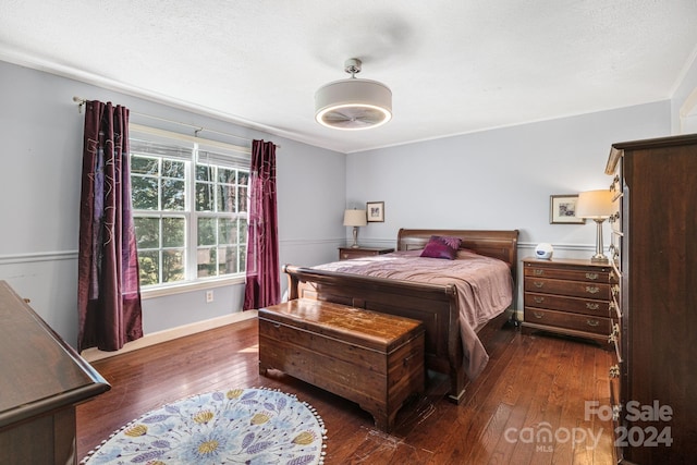 bedroom featuring a textured ceiling and dark wood-type flooring