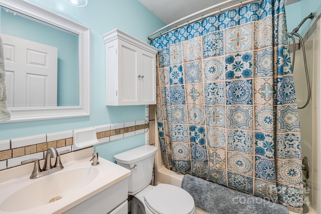 full bathroom featuring vanity, toilet, tile walls, and shower / bath combo with shower curtain