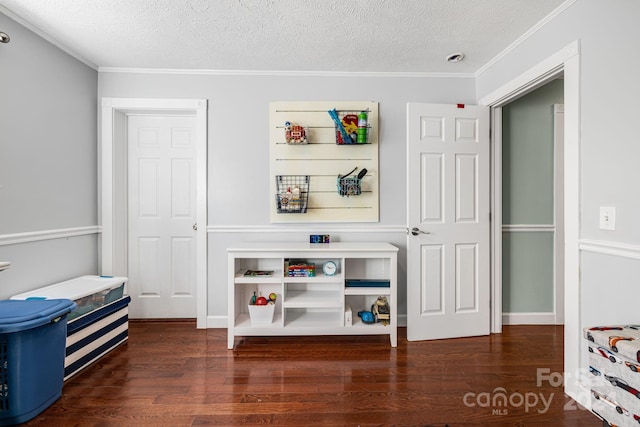 rec room featuring dark hardwood / wood-style flooring, a textured ceiling, and crown molding