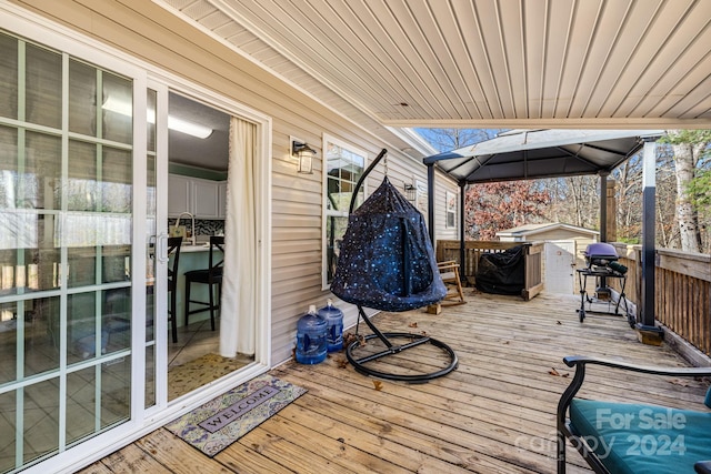 wooden deck featuring grilling area and sink