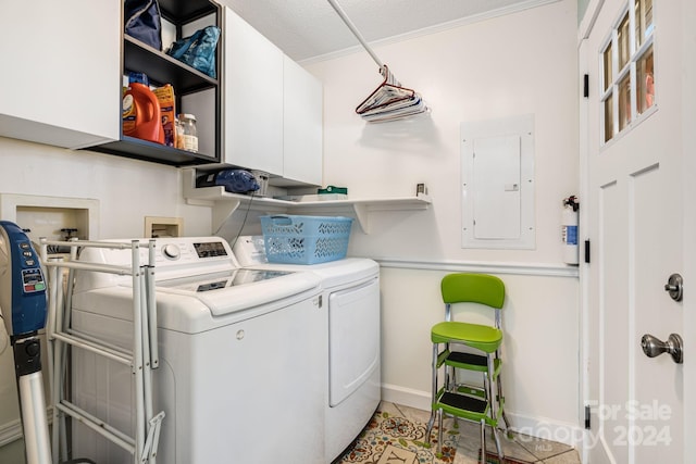 laundry room with washer and clothes dryer, cabinets, electric panel, a textured ceiling, and light tile patterned flooring