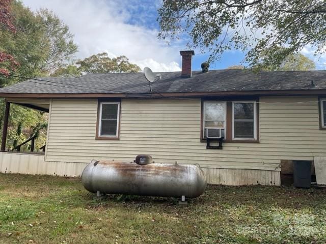 rear view of house featuring a lawn