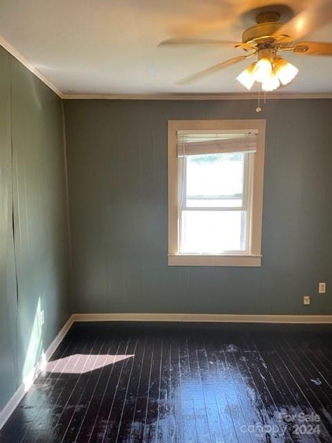 empty room with dark wood-type flooring, crown molding, and ceiling fan