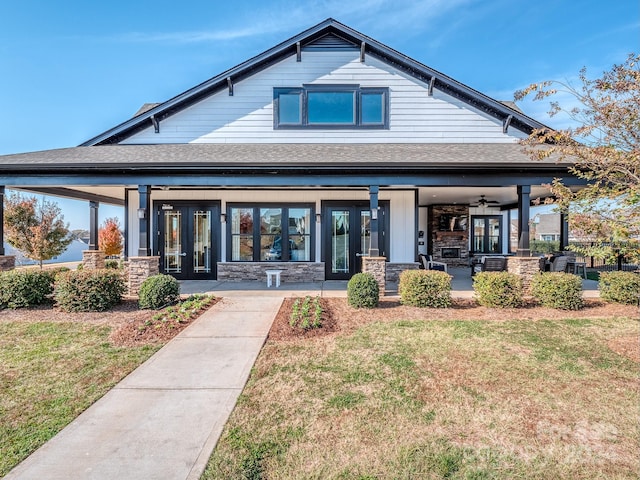 back of property featuring a lawn and ceiling fan