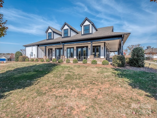 new england style home with a front lawn and covered porch