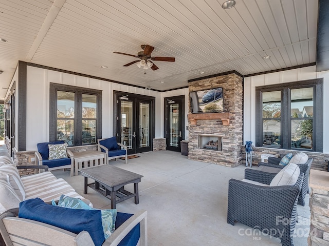 view of patio with ceiling fan and an outdoor living space with a fireplace