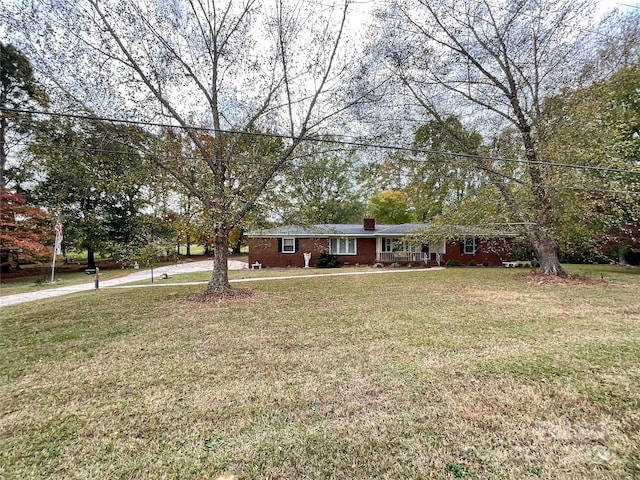 ranch-style home with a front lawn