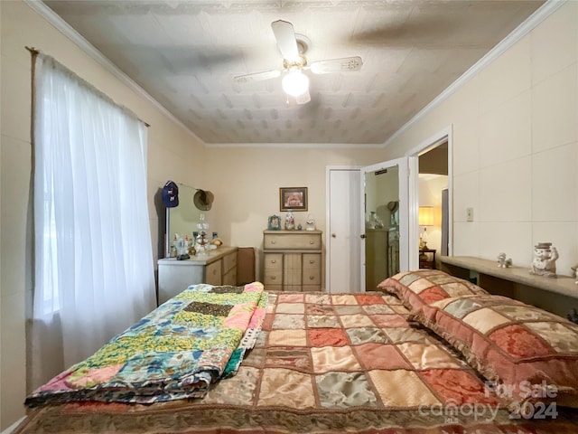 bedroom with ceiling fan, multiple windows, and ornamental molding