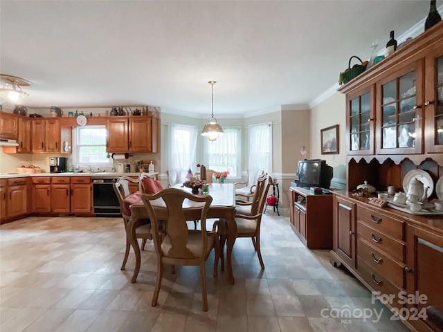 dining room with sink and ornamental molding