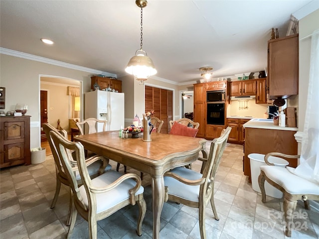 dining space with sink and ornamental molding