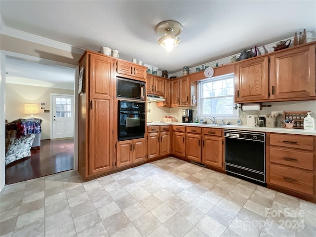 kitchen featuring black appliances, sink, and ornamental molding