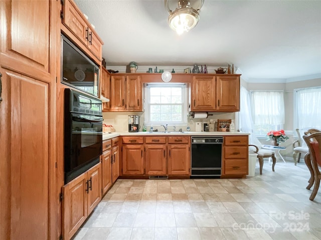 kitchen featuring black appliances, sink, and ornamental molding