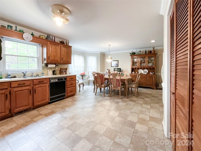 kitchen featuring decorative light fixtures, a wealth of natural light, sink, and black dishwasher