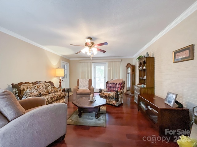 living room with dark hardwood / wood-style flooring, brick wall, ceiling fan, and crown molding