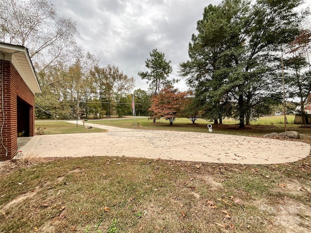 view of community with volleyball court and a yard