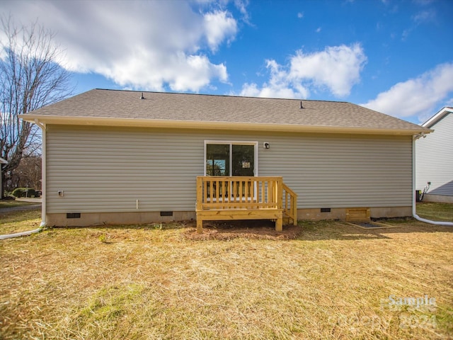 back of property featuring a yard