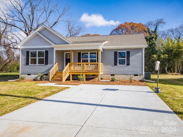 view of front of house with central AC unit, a porch, and a front yard