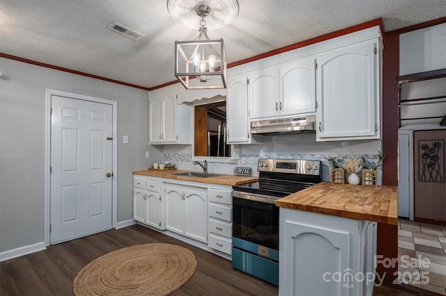 kitchen with electric range, white cabinets, butcher block counters, decorative light fixtures, and under cabinet range hood