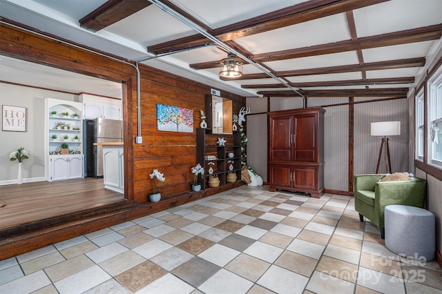 interior space with wood walls, coffered ceiling, and beam ceiling