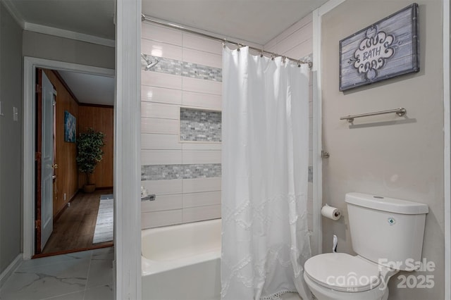 full bathroom featuring toilet, marble finish floor, crown molding, and shower / tub combo