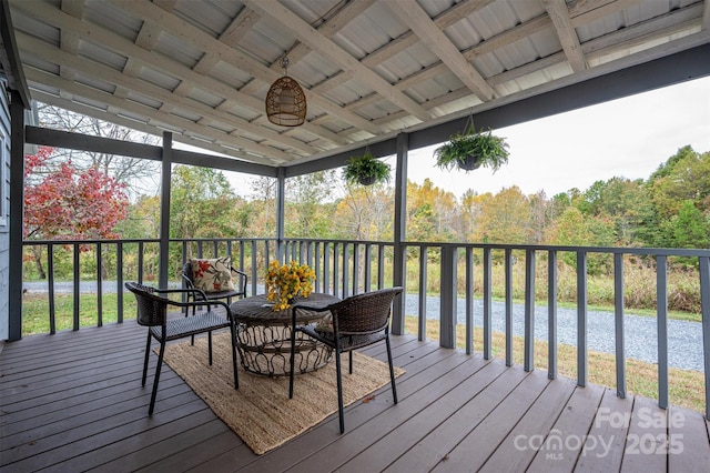 wooden terrace featuring outdoor dining area