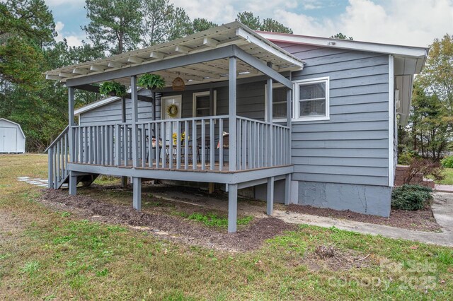 back of house featuring a yard and a deck