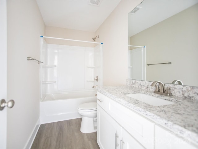 full bathroom with hardwood / wood-style floors, vanity, shower / bath combination, and toilet