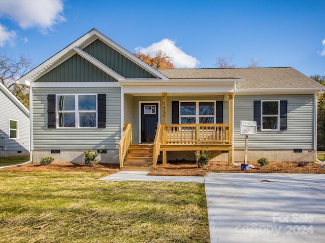 view of front of house with a porch and a front lawn