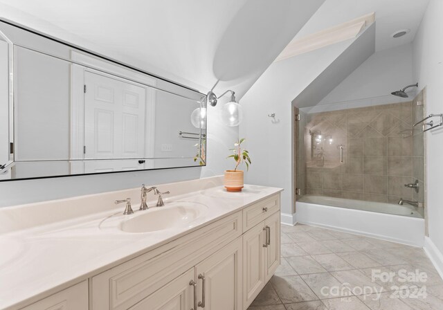 bathroom with vanity and tiled shower / bath