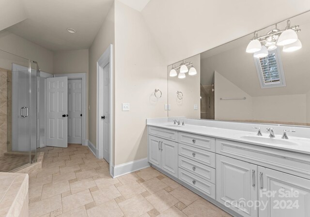 bathroom featuring a shower with door, vanity, and lofted ceiling