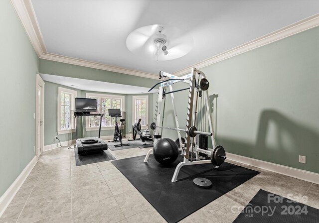 exercise room with ornamental molding, light tile patterned floors, and ceiling fan