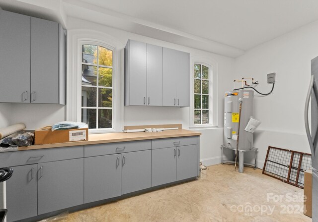 kitchen featuring gray cabinetry and water heater