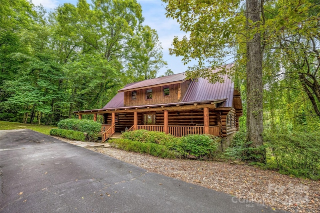 log-style house featuring a porch