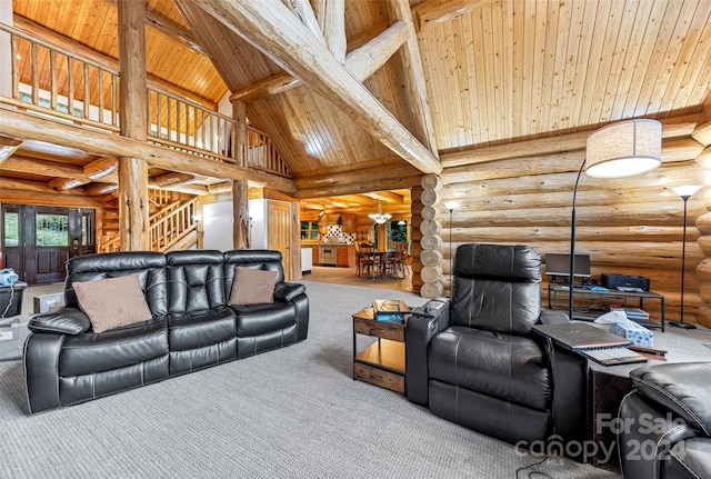 carpeted living room featuring beam ceiling, rustic walls, high vaulted ceiling, and wood ceiling