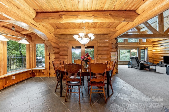 dining room with log walls, a chandelier, dark colored carpet, and wooden ceiling