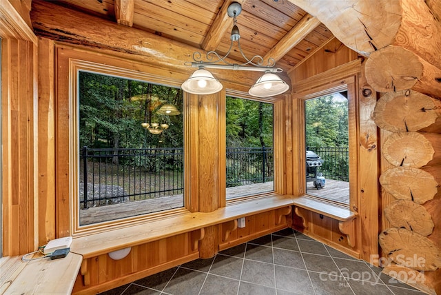 unfurnished sunroom featuring vaulted ceiling with beams and wood ceiling