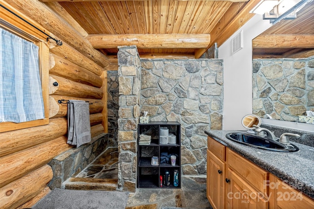 bathroom with vanity, beamed ceiling, wooden ceiling, and log walls