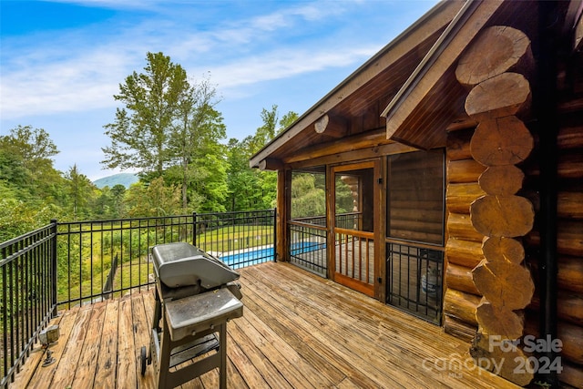 wooden terrace featuring a pool