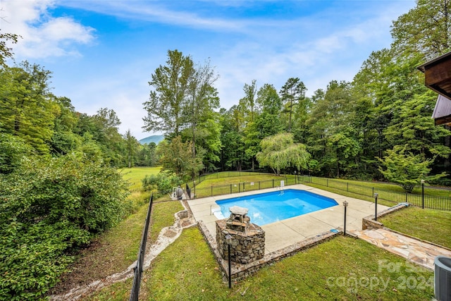 view of pool with a patio area, a lawn, and central AC unit