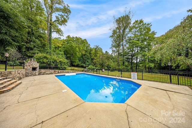 view of pool featuring a patio and a lawn