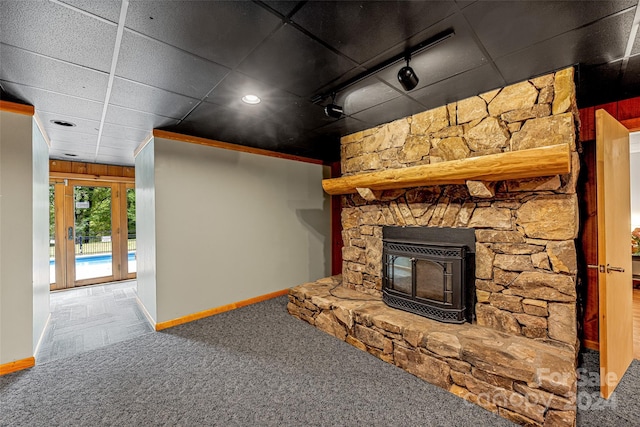 unfurnished living room with a paneled ceiling and carpet floors