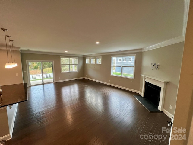 unfurnished living room with ornamental molding and dark hardwood / wood-style floors