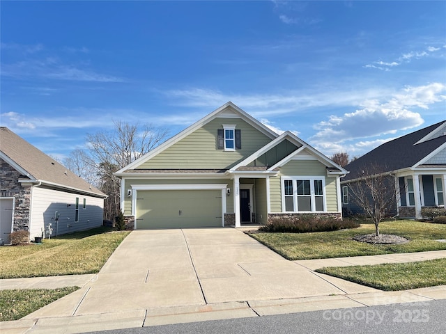 view of front of house with a garage, driveway, a front lawn, and stone siding