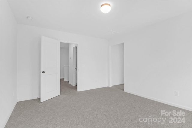 spare room with light colored carpet