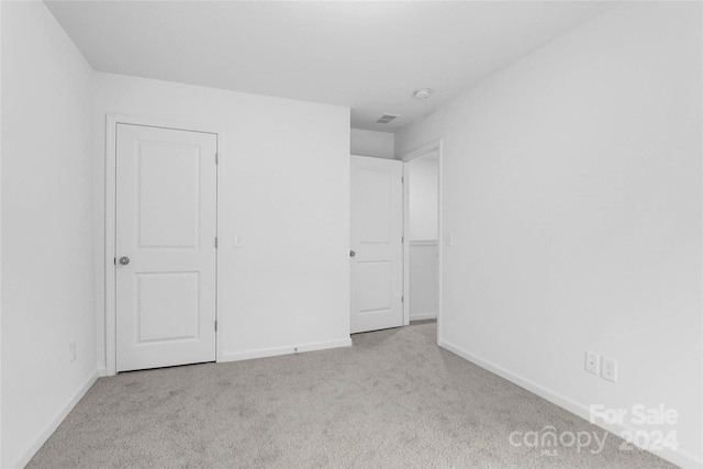 unfurnished bedroom with light carpet