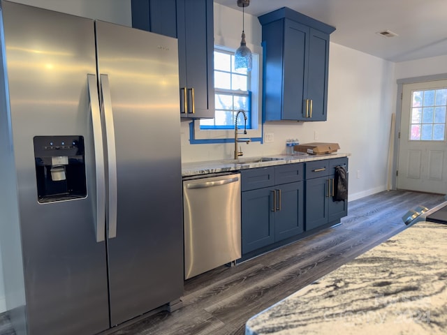 kitchen featuring appliances with stainless steel finishes, sink, dark wood-type flooring, and a wealth of natural light